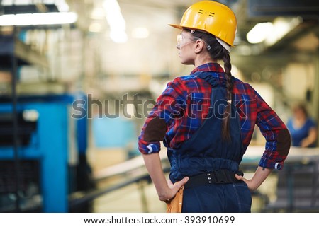 Female engineer in helmet controlling the process