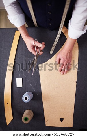 Directly above shot of tailor working in atelier studio, making business suit