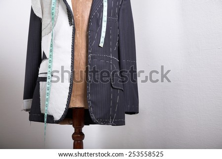Semi-ready, elegant tailor made suit on dress stand
