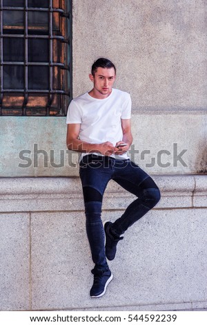 Man wearing white dress shirt standing sideways. Man wearing white dress shirt standing sideways.