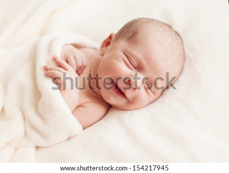Smiling newborn baby 6 days old