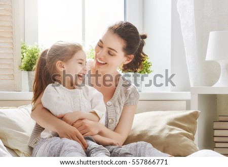 Happy loving family. Mother and her daughter child girl playing and hugging.