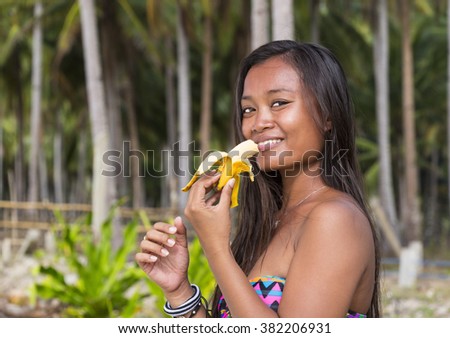 https://thumb7.shutterstock.com/display_pic_with_logo/929752/382206931/stock-photo-filipina-beautiful-girl-eats-a-banana-in-nature-382206931.jpg