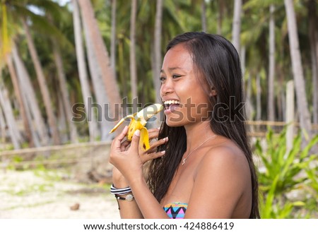 https://thumb7.shutterstock.com/display_pic_with_logo/929752/424886419/stock-photo-filipina-beautiful-girl-eats-a-banana-in-nature-424886419.jpg
