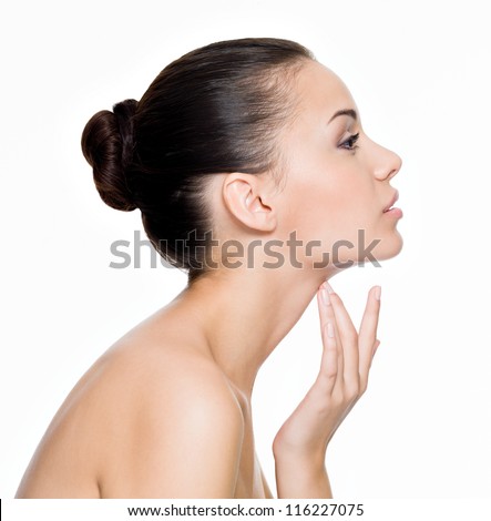 Beautiful woman cares for the skin neck- posing at studio isolated on white