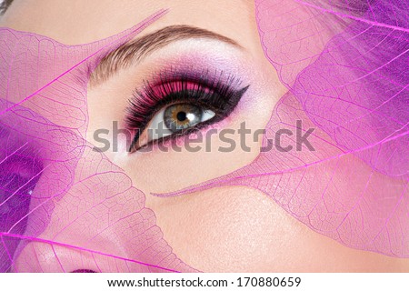 Closeup female eye with beautiful fashion bright pink makeup