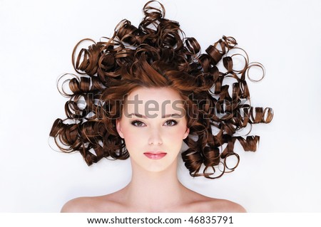 high angle portrait of the pretty young woman with beauty curly hairs -lyin? on the floor