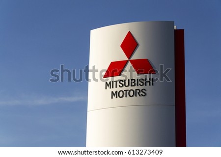 PRAGUE, CZECH REPUBLIC - MARCH 31: Mitsubishi motors company logo with Mazda car in front of dealership building on March 31, 2017 in Prague, Czech republic.