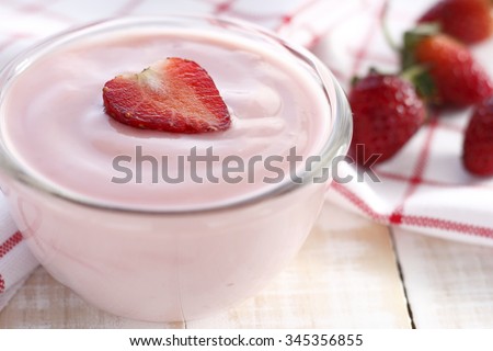 strawberry yogurt with fresh strawberry in heart-like formed on wooden white background. strawberry yoghurt. pink yogurt. strawberry in strawberry yogurt. heart in yogurt. heart. valentine 's day.