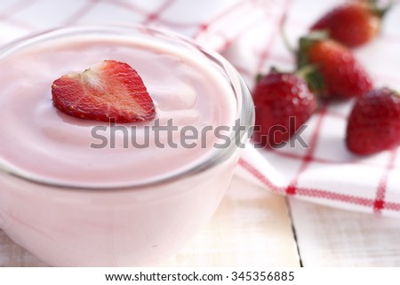 strawberry yogurt with fresh strawberry in heart-like formed on wooden white background. strawberry yoghurt. pink yogurt. strawberry in strawberry yogurt. heart in yogurt. heart. valentine 's day.