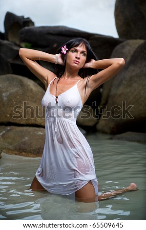 stock photo sexy brunette in white wet dress posing in the water 65509645