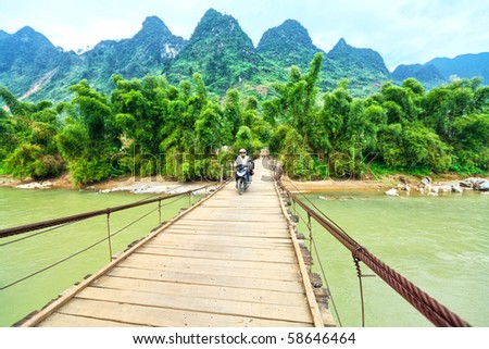 Wooden bridge over mountain river. Northern Vietnam