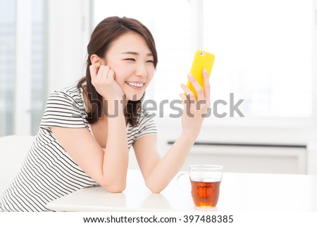 young attractive asian woman to see a smart phone