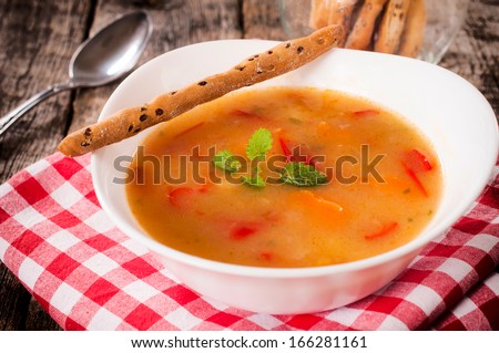 Vegetarian soup in the bowl with salted sticks.Selective focus on the soup - stock photo