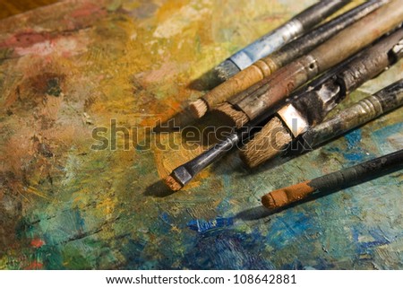 oil paints and paint brushes on a palette