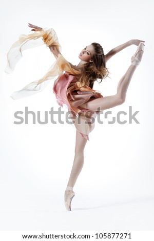 young beautiful dancer posing on a studio background
