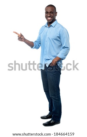 Young african guy pointing copy space area - stock photo