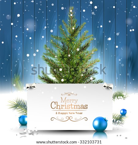 Christmas greeting card with Christmas tree on wooden background
