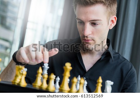 business competition concept with man playing chess game board
