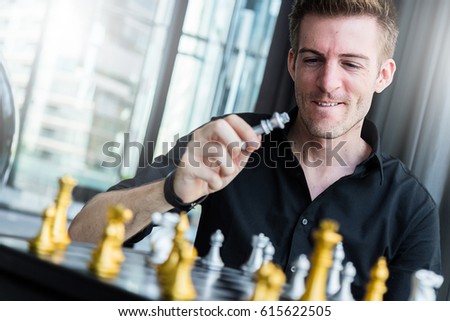 business competition concept with man playing chess game board