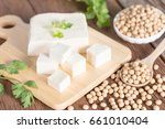 Tofu with soy bean on wooden board.