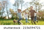 Small photo of group of children running in the park. happy family baby kid dream concept. kindergarten. children hands to the sides play pilots plane run on the grass in the summer in the lifestyle park