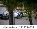 Small photo of Northridge, CA / United States - May 27, 2019: LAPD Patrol Units respond to brandishing/ADW call in suburban neighborhood with less lethal device. A LAPD officer is shown removing the device.