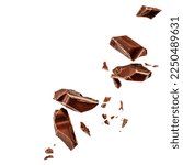 Small photo of  Levitating milk chocolate chunks isolated on white background. Flying Chocolate pieces, shavings and cocoa crumbs Top view. Flat lay