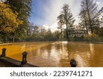 Small photo of FURNAS, AZORES, PORTUGAL - DECEMBER 4th: Thermal pool in Terra Nostra park, a popular tourist destination on December 4th, 2022 in Furnas, Portugal. The orange color comes from the oxidated iron in