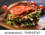 BLT sandwich with fried bacon, lettuce and tomato in slices of bread