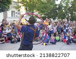 Performer at Cest is d’best street festival with a fire wheel making circle of fire