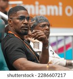 Small photo of MIAMI GARDENS, FLORIDA - MARCH 30, 2023: An American actor, comedian and singer Jamie Foxx attends the quarter-final match at 2023 Miami Open at the Hard Rock Stadium, Miami Gardens, Florida, USA