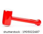Small photo of Red inflatable hammer isolated on white background, baby's toy for children to blow up the air in the balloon and sway