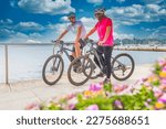 Active couple riding an E-Bike during vacations in the south
