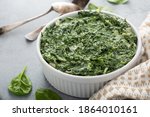 Creamed spinach with garlic in a white bowl