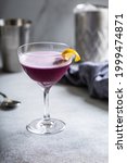 Small photo of Purple puritan cocktail with gin, vermouth and bitters, Halloween cocktail