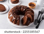 Small photo of Chocolate cake baked in a bundt pan with chocolate ganache glaze and chocolate curls sliced