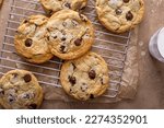 Chocolate chip cookies with flaky salt on a cooling rack, homemade freshly baked cookies