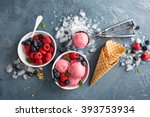 Raspberry ice cream in white bowl overhead shot