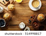 Freshly baked blueberry muffins in a rustic setting with milk and coffee on the table overhead shot with copyspace