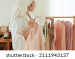 Cropped image of woman choosing clothes to wear after morning shower