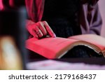 Small photo of Close-up image of witch reading spell in old book to exorcise the evil spirit