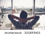 Man relaxing in his chair and enjoying the view from office window