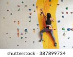 Athletic Woman Climbing Indoors ...