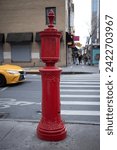 Small photo of A 20th-century vintage red fire call box in NYC. Usually installed on street corners, used to notify the fire department of a fire before the general availability of telephones.