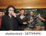 Small photo of SPITAK, ARMENIA - OCTOBER 1: Tony Iommi of Black Sabbath and famous Australian professional tennis player Pat Cash enjoy refreshments as they visit Spitak, Armenia on October 1, 2009.