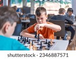 Small photo of A school kid taking part in a chess tournament