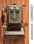 Small photo of Replica of an AD1907 Paramount Antique Classic Wooden Wall Mounted Landline Phone with push button dial in rotary plate, handset with brown felted cord, antique metal accents, brass ringers and crank.