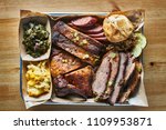 Small photo of texas bbq style tray with smoked beef brisket, st louis ribs, chicken and hot links