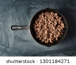cooked ground beef in cast iron skillet flat lay composition